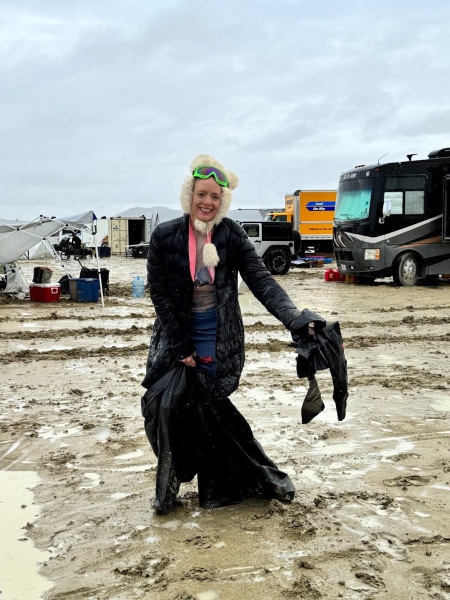 Camper standing in deep mud at a festival RV camp